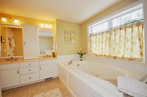 71 Chamberlain Road Westford, MA 01886 - Photo 18 of 30 a spacious bathroom with a tub sink and mirror
