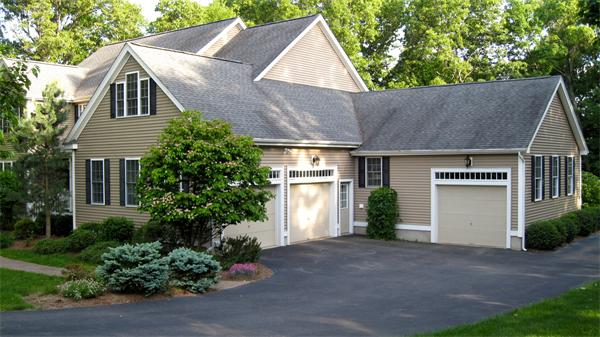 71 Chamberlain Road Westford, MA 01886 - Photo 2 of 30 a front view of a house with a yard and garage