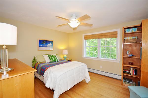 71 Chamberlain Road Westford, MA 01886 - Photo 22 of 30 a bedroom with a bed and a chandelier