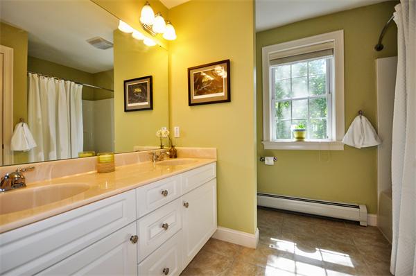 71 Chamberlain Road Westford, MA 01886 - Photo 23 of 30 a spacious bathroom with a double vanity sink a mirror and a bathtub