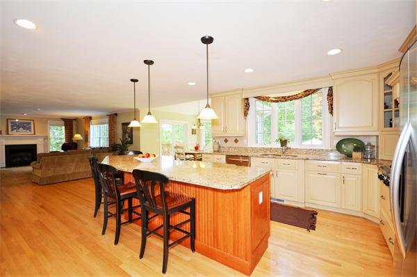 71 Chamberlain Road Westford, MA 01886 - Photo 9 of 30 a kitchen with stainless steel appliances kitchen island granite countertop a sink and cabinets