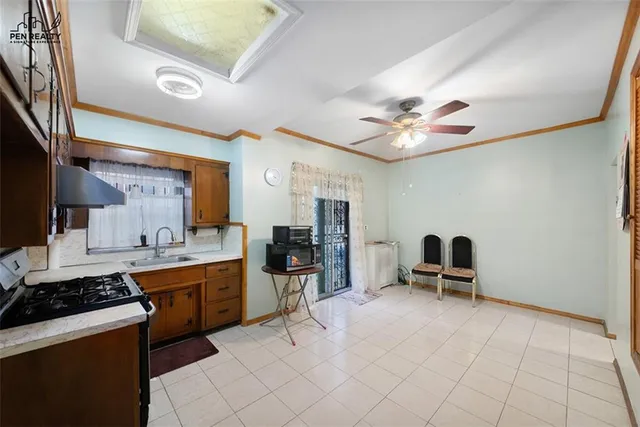 a view of kitchen with sink dining table and chairs