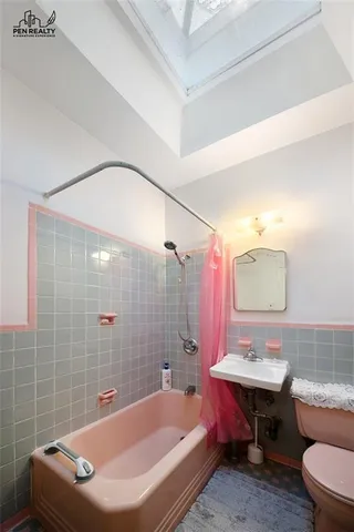 a bathroom with a sink a toilet a shower and bathtub