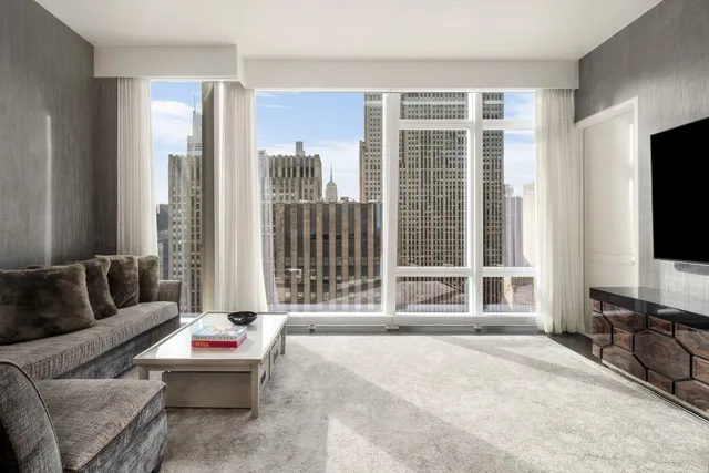 a large bathroom with a double vanity sink large mirror and a bathtub