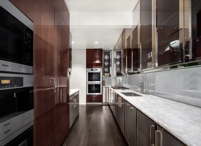 a living room with dining room and chandelier
