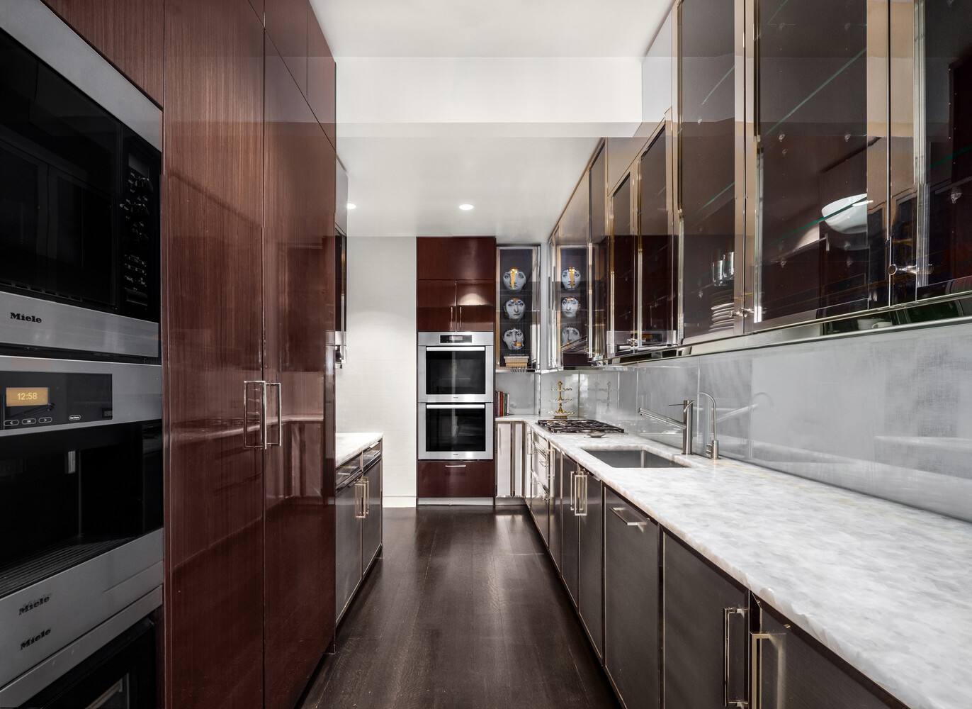 20 West 53rd Street, Unit 38A Manhattan, NY 10019 - Photo 6 of 20 a kitchen with stainless steel appliances granite countertop a refrigerator a stove and a sink