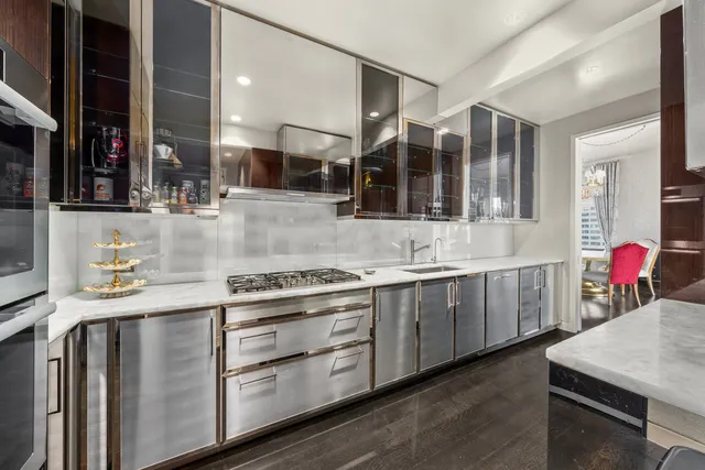 a kitchen with stainless steel appliances granite countertop a refrigerator a stove and a sink