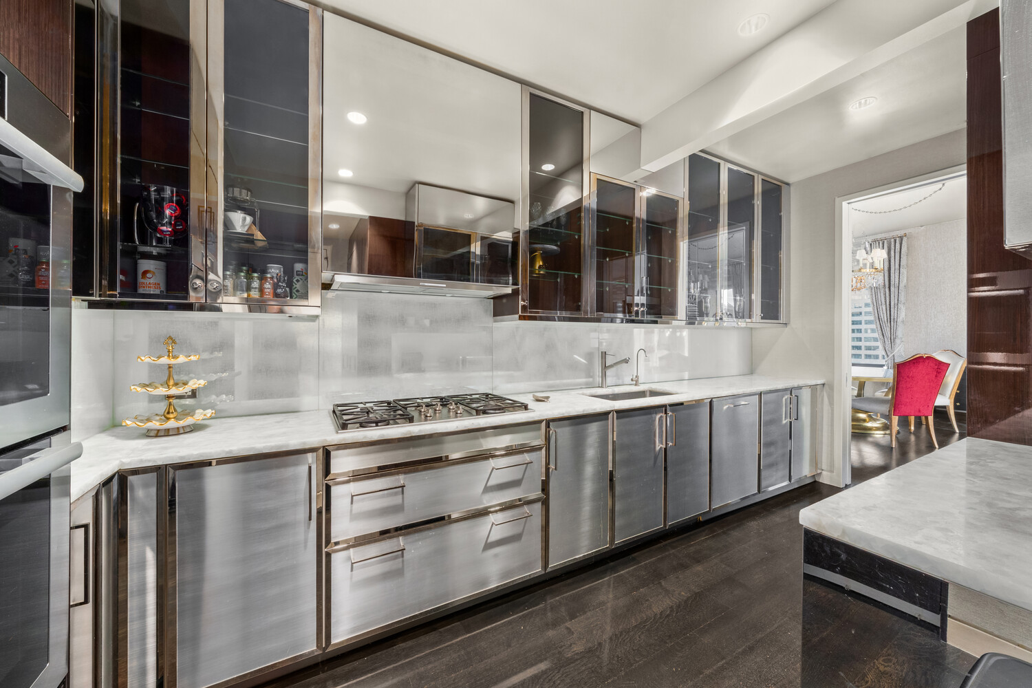 20 West 53rd Street, Unit 38A Manhattan, NY 10019 - Photo 7 of 20 a kitchen with stainless steel appliances granite countertop a stove and cabinets