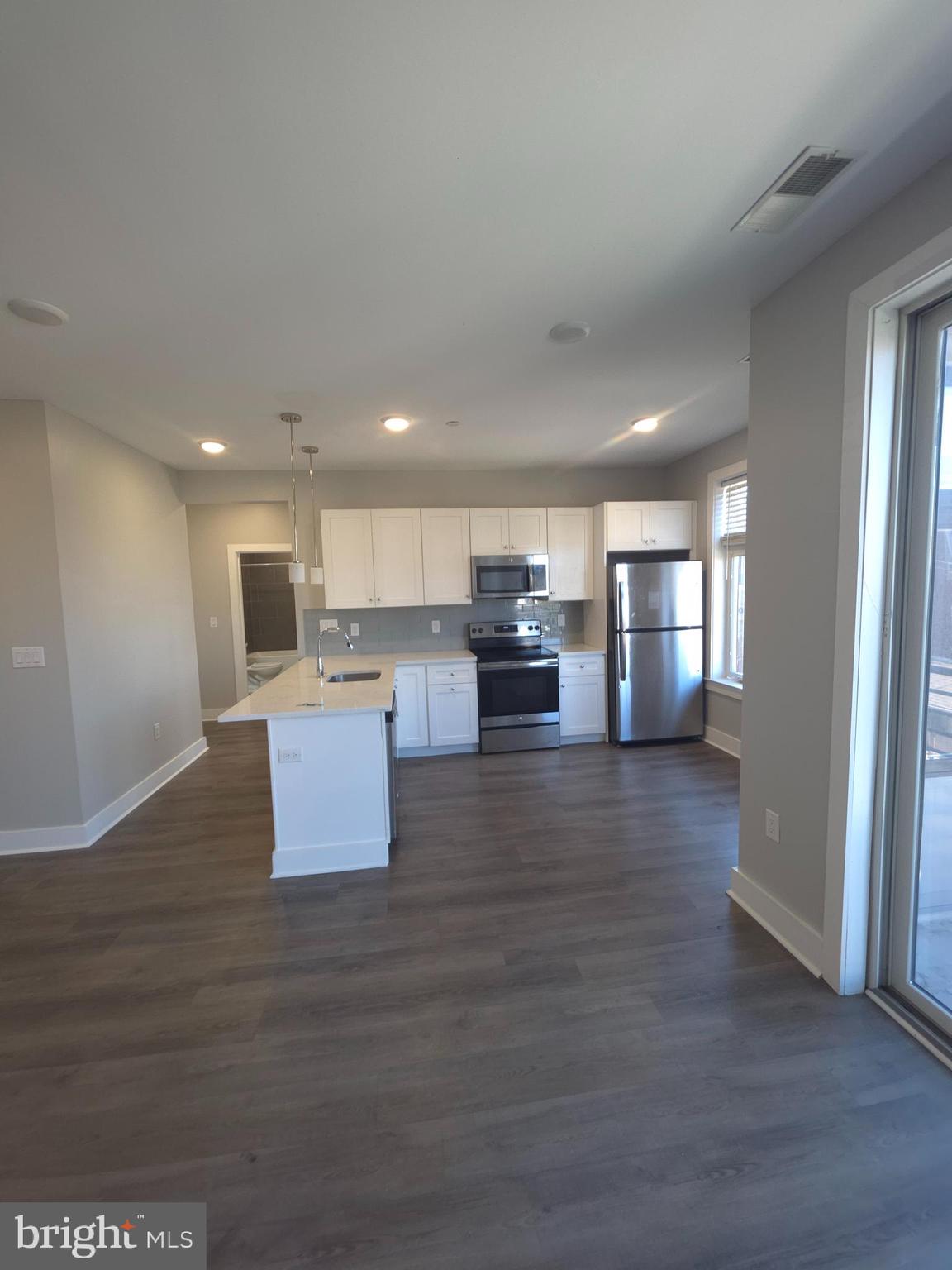 3925 Haverford Avenue, Unit 307 Philadelphia, PA 19104 - Photo 20 of 37 a living room with stainless steel appliances kitchen island granite countertop a large kitchen counter top and view living room