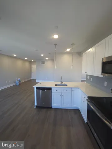 a large kitchen with a sink and dishwasher stove top oven