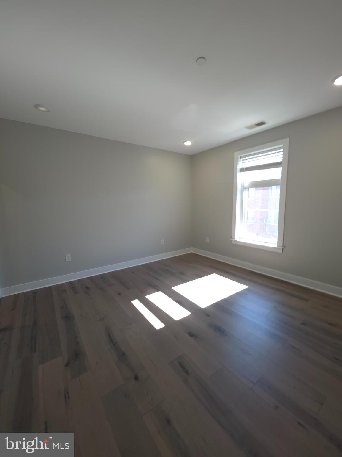 3925 Haverford Avenue, Unit 307 Philadelphia, PA 19104 - Photo 27 of 37 an empty room with wooden floor and windows