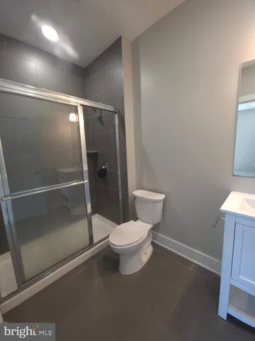 a bathroom with a toilet and a shower