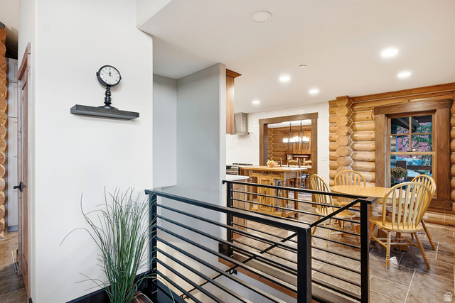 12465 Bone Road Kamas, UT 84036 - Photo 44 of 63 Open-concept living space with log wall accents, recessed lighting, and a modern horizontal metal railing