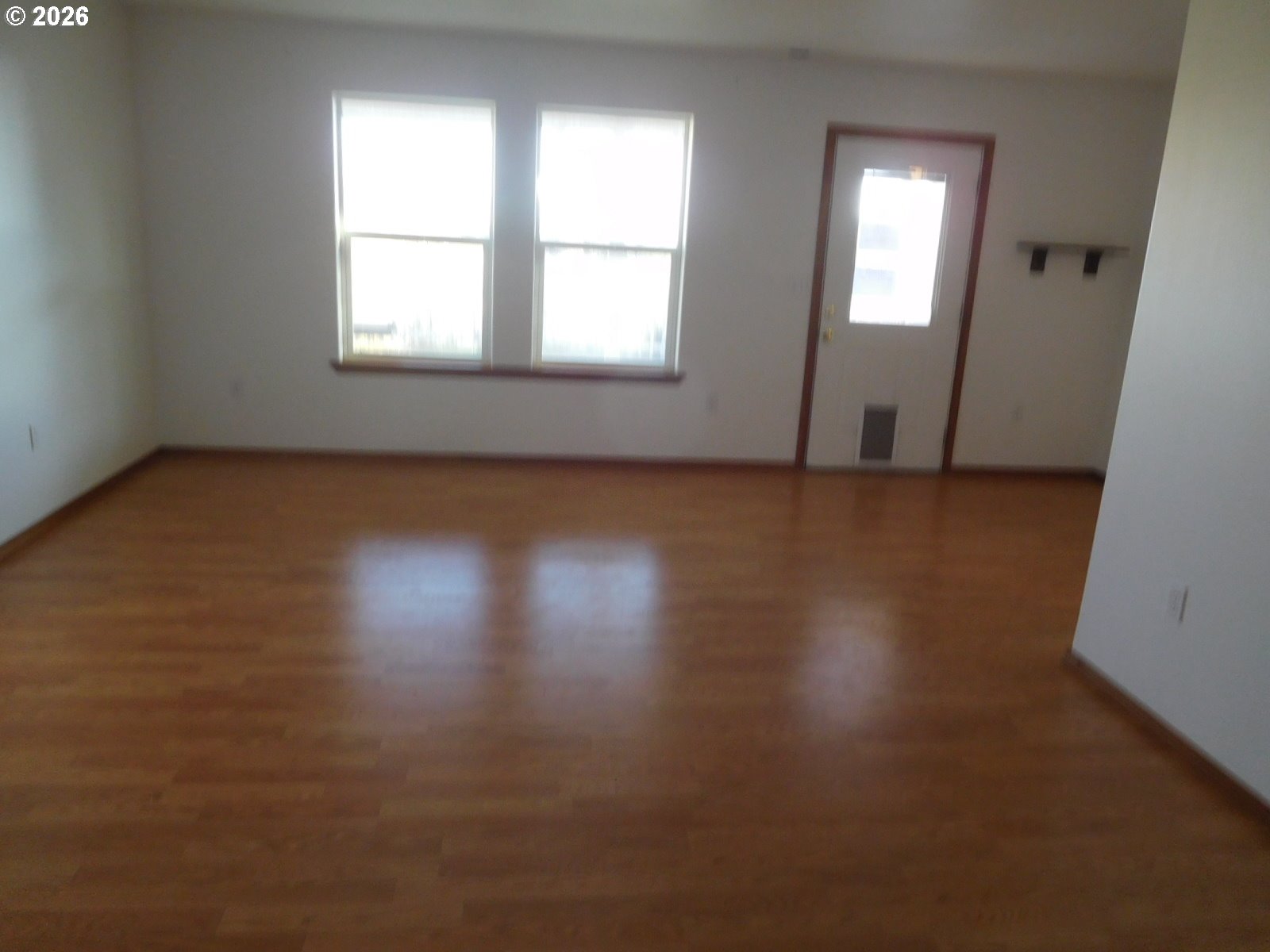 815 North Main Street Pendleton, OR 97801 - Photo 12 of 35 an empty room with wooden floor and windows