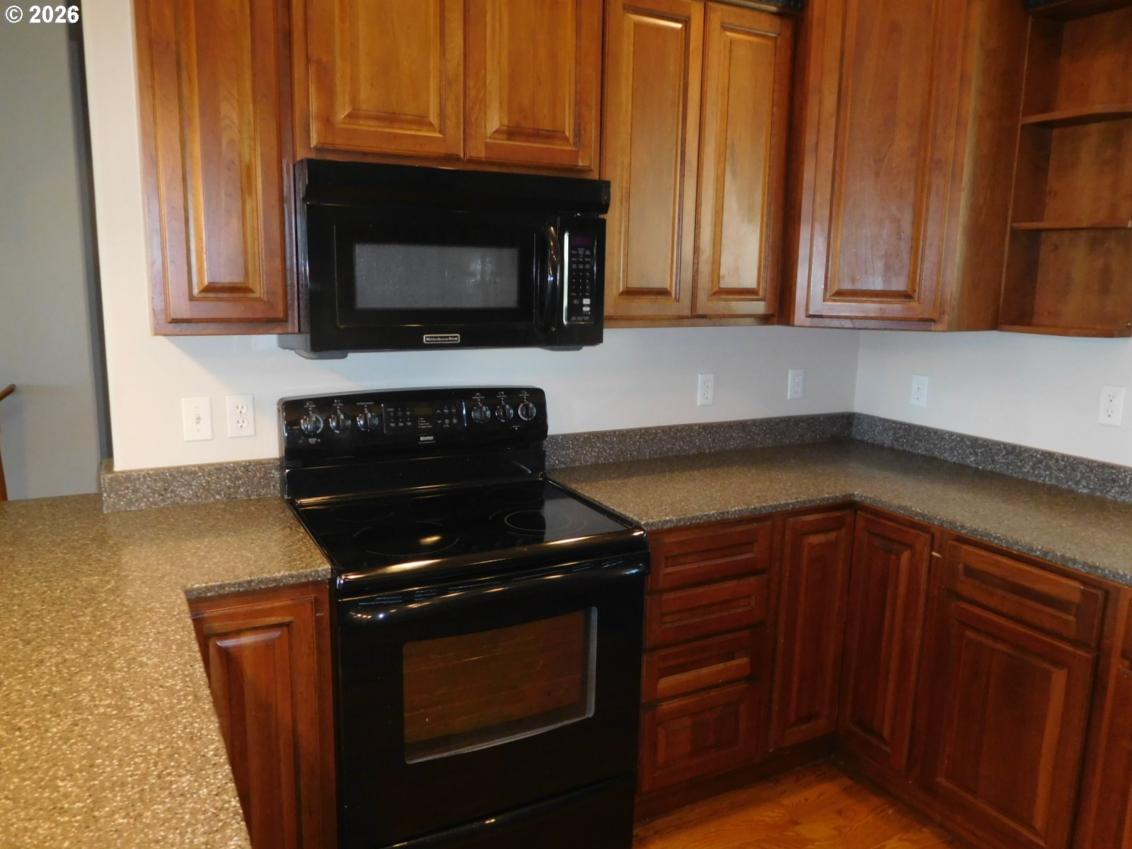 815 North Main Street Pendleton, OR 97801 - Photo 19 of 35 a kitchen with granite countertop a stove and a microwave with cabinets