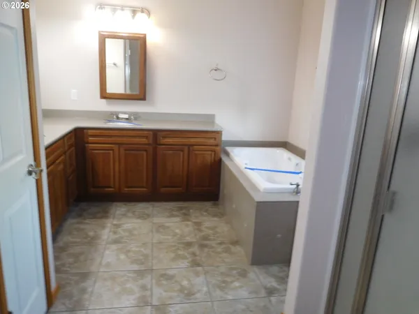 a bathroom with a window and a shower