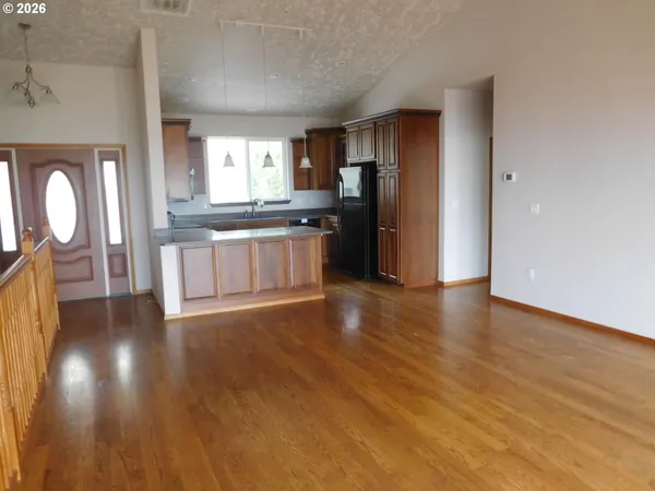 a kitchen with granite countertop a stove and a microwave