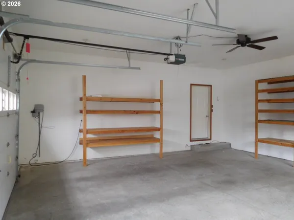 a view of an empty room with a ceiling fan