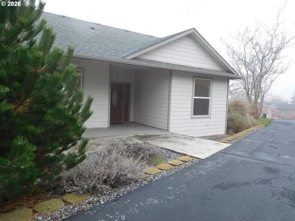 a view of a house with a yard and garage