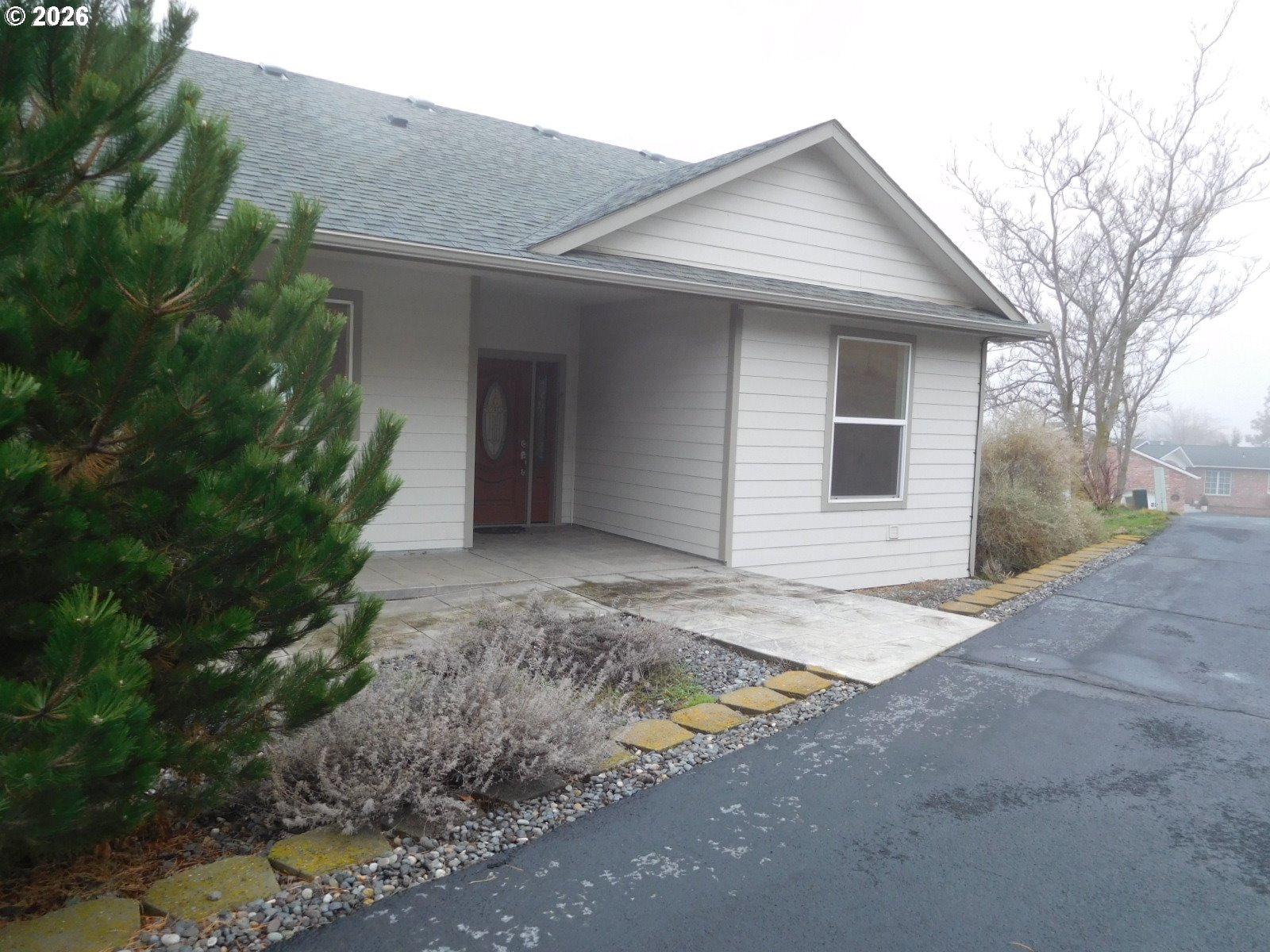 815 North Main Street Pendleton, OR 97801 - Photo 4 of 35 a view of a house with a yard and garage