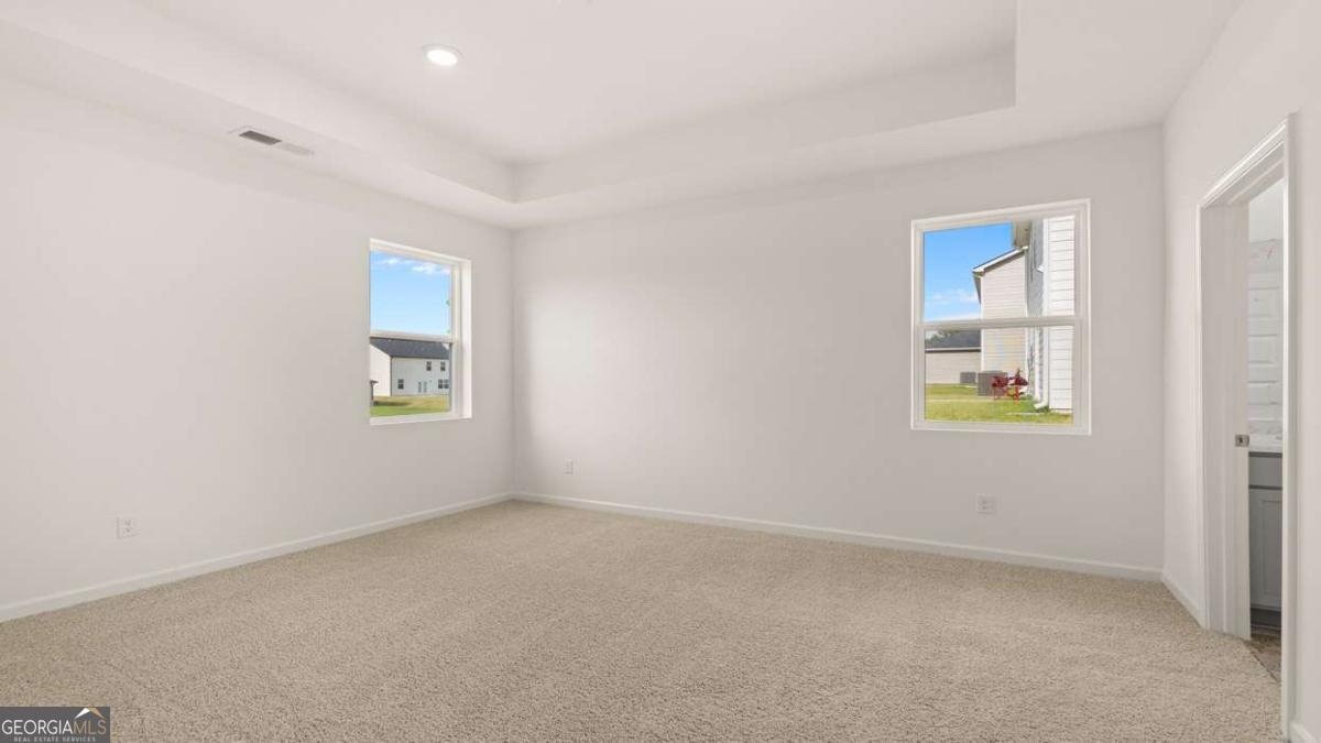 8576 Seabiscuit Road Lithonia, GA 30058 - Photo 13 of 22 an empty room with windows