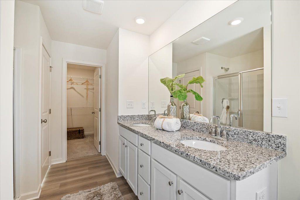 2526 Riverside Court Northeast Conyers, GA 30013 - Photo 13 of 22 a bathroom with a granite countertop double vanity sink and a mirror