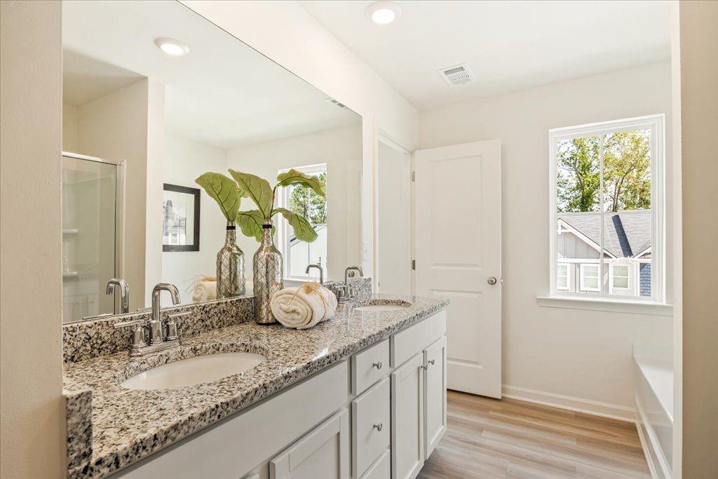 2526 Riverside Court Northeast Conyers, GA 30013 - Photo 15 of 22 a bathroom with a granite countertop sink and a mirror