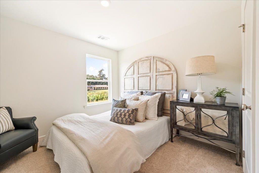 2526 Riverside Court Northeast Conyers, GA 30013 - Photo 8 of 22 a bedroom with a bed and a large window