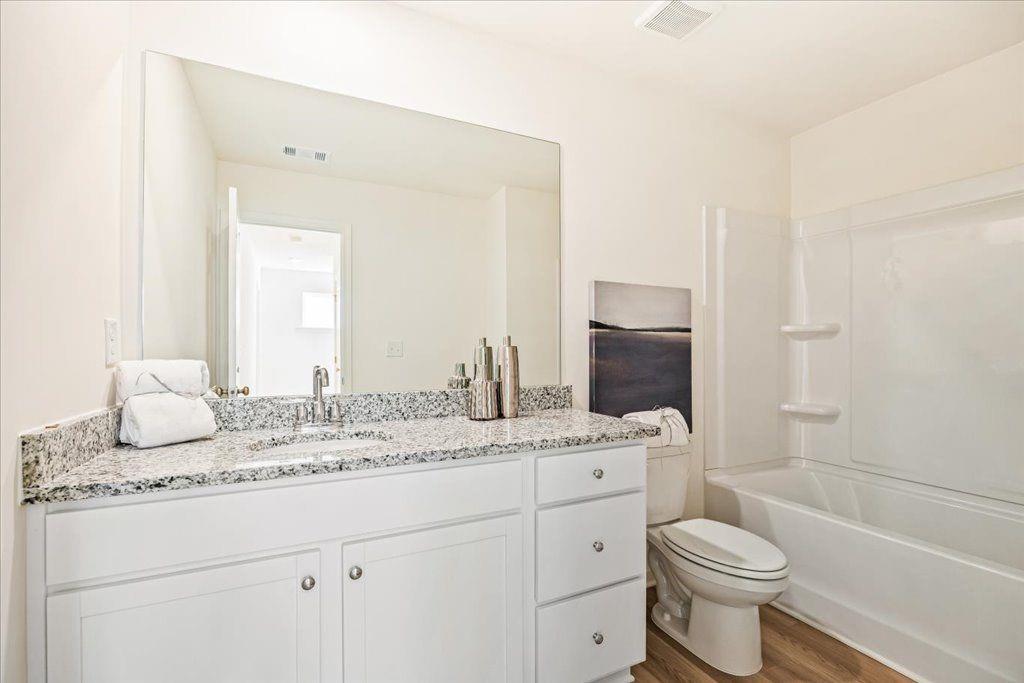 2526 Riverside Court Northeast Conyers, GA 30013 - Photo 10 of 22 a bathroom with a granite countertop toilet sink and a mirror