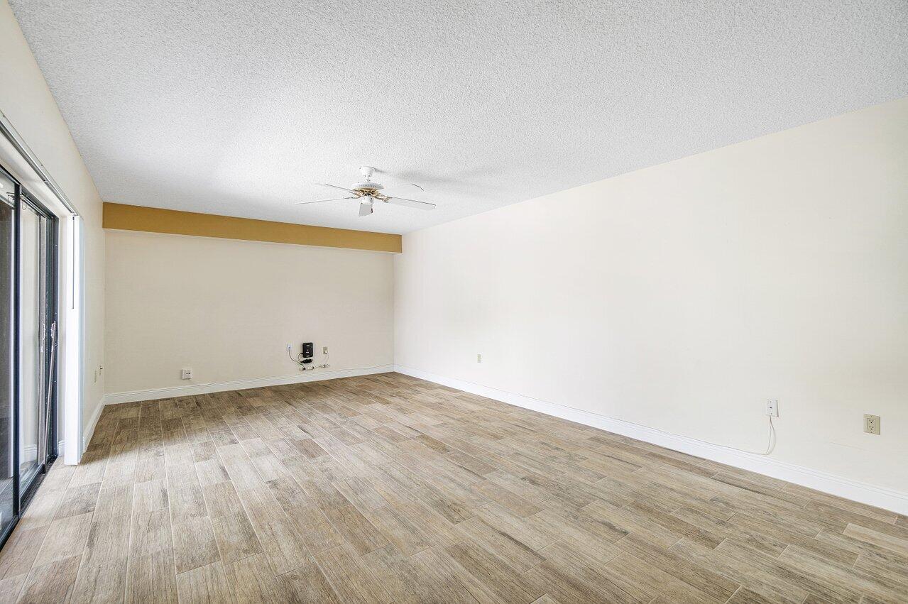 1619 16th Court Jupiter, FL 33477 - Photo 12 of 31 an empty room with wooden floor