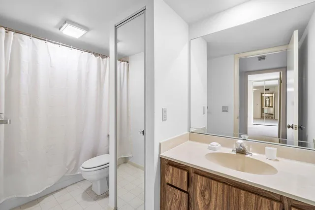 a view of a room with a ceiling fan and window