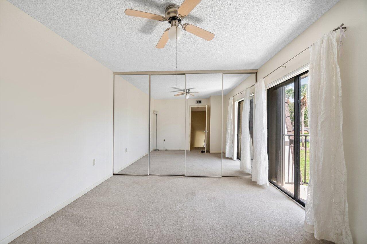 1619 16th Court Jupiter, FL 33477 - Photo 19 of 31 a view of a room with a ceiling fan and window