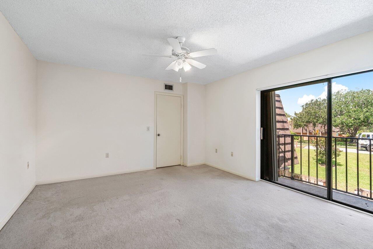 1619 16th Court Jupiter, FL 33477 - Photo 22 of 31 wooden floor in an empty room with a window