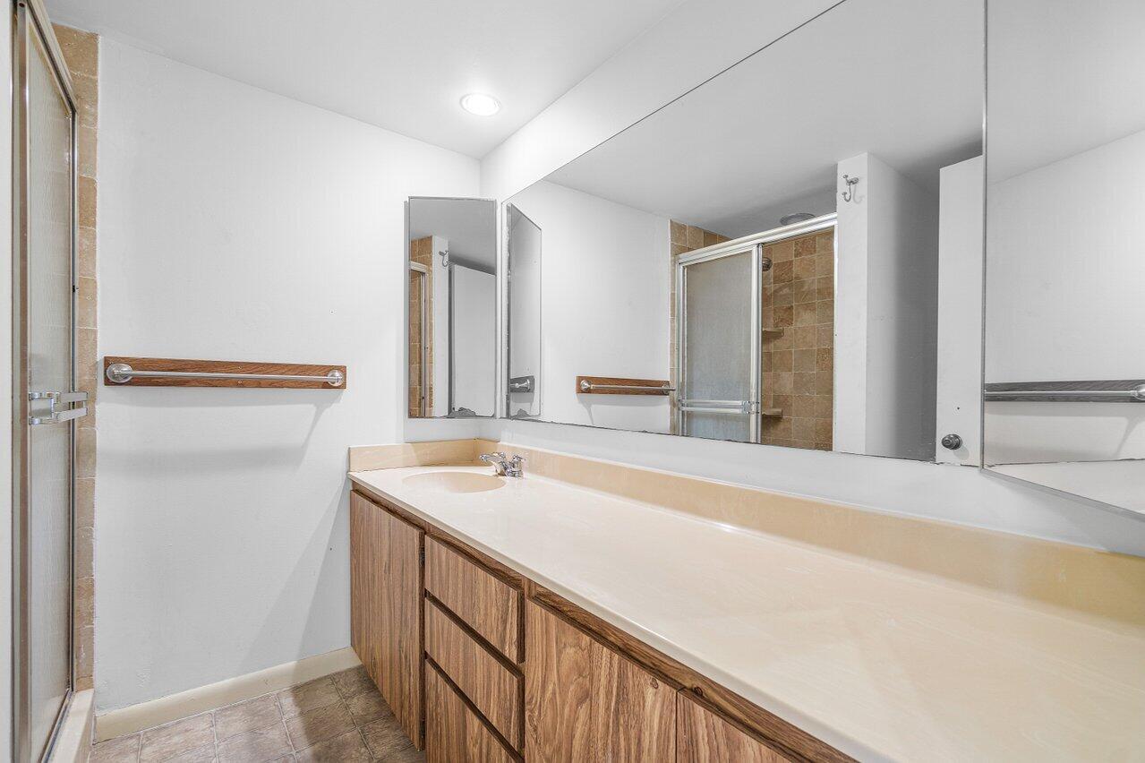 1619 16th Court Jupiter, FL 33477 - Photo 23 of 31 a bathroom with a sink and a mirror
