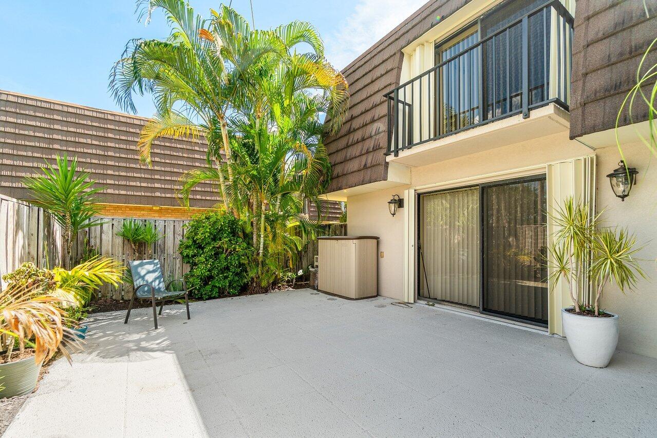 1619 16th Court Jupiter, FL 33477 - Photo 5 of 31 a view of a house with porch and potted plants