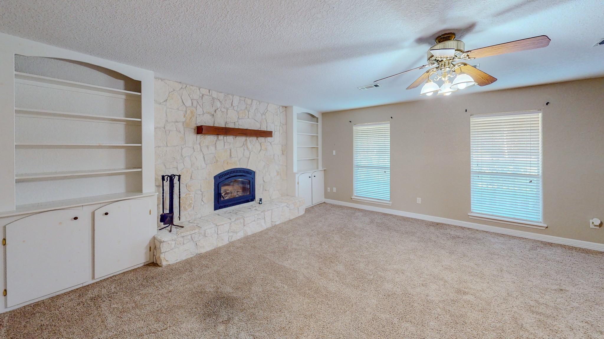 4770 County Road 31 Angleton, TX 77515 - Photo 10 of 44 Living with built in storage, fireplace, and natural light