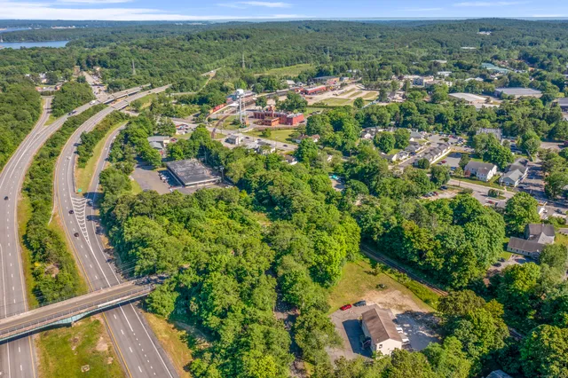 an aerial view of residential houses with outdoor space and street view
