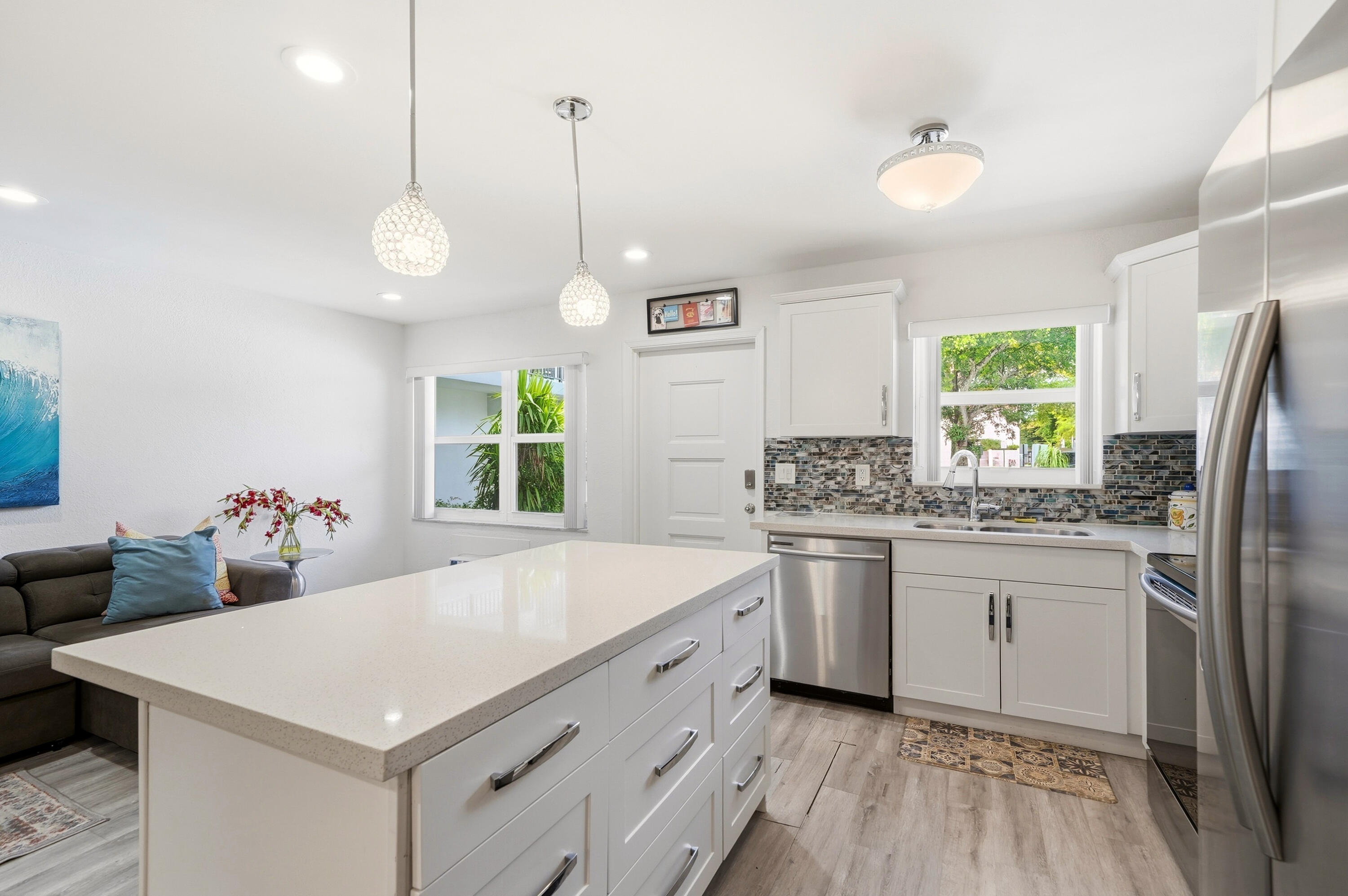 3510 Harrison Street, Unit 4 Hollywood, FL 33021 - Photo 11 of 31 a kitchen with a stove a refrigerator a sink dishwasher with wooden floor dining table and chairs