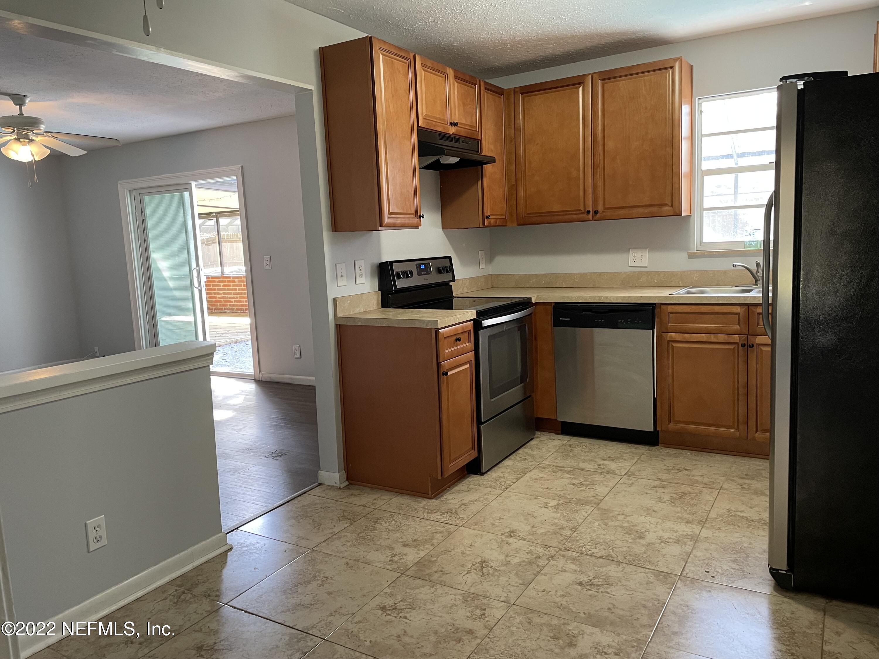 11651 Mandarin Road Jacksonville, FL 32223 - Photo 8 of 16 a kitchen with stainless steel appliances granite countertop a refrigerator a stove top oven a sink and dishwasher