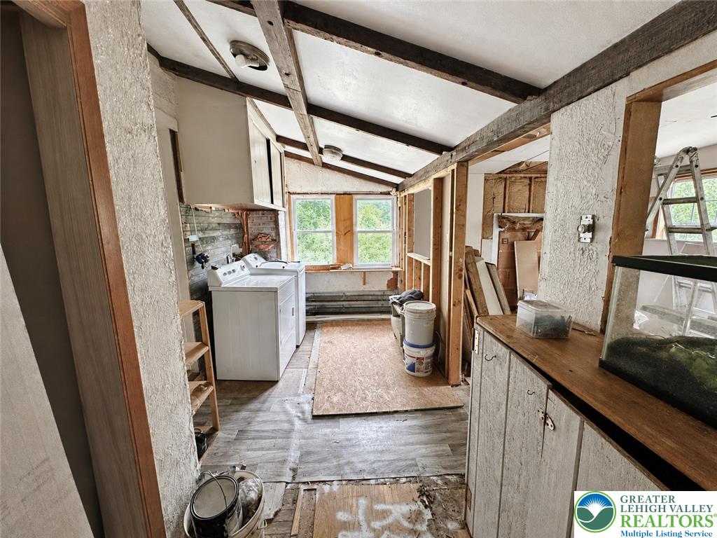 3540 Mountain Road, Unit 3538 Slatington, PA 18080 - Photo 10 of 27 Exposed wood beams and vaulted ceilings define this utility area awaiting custom finishes.