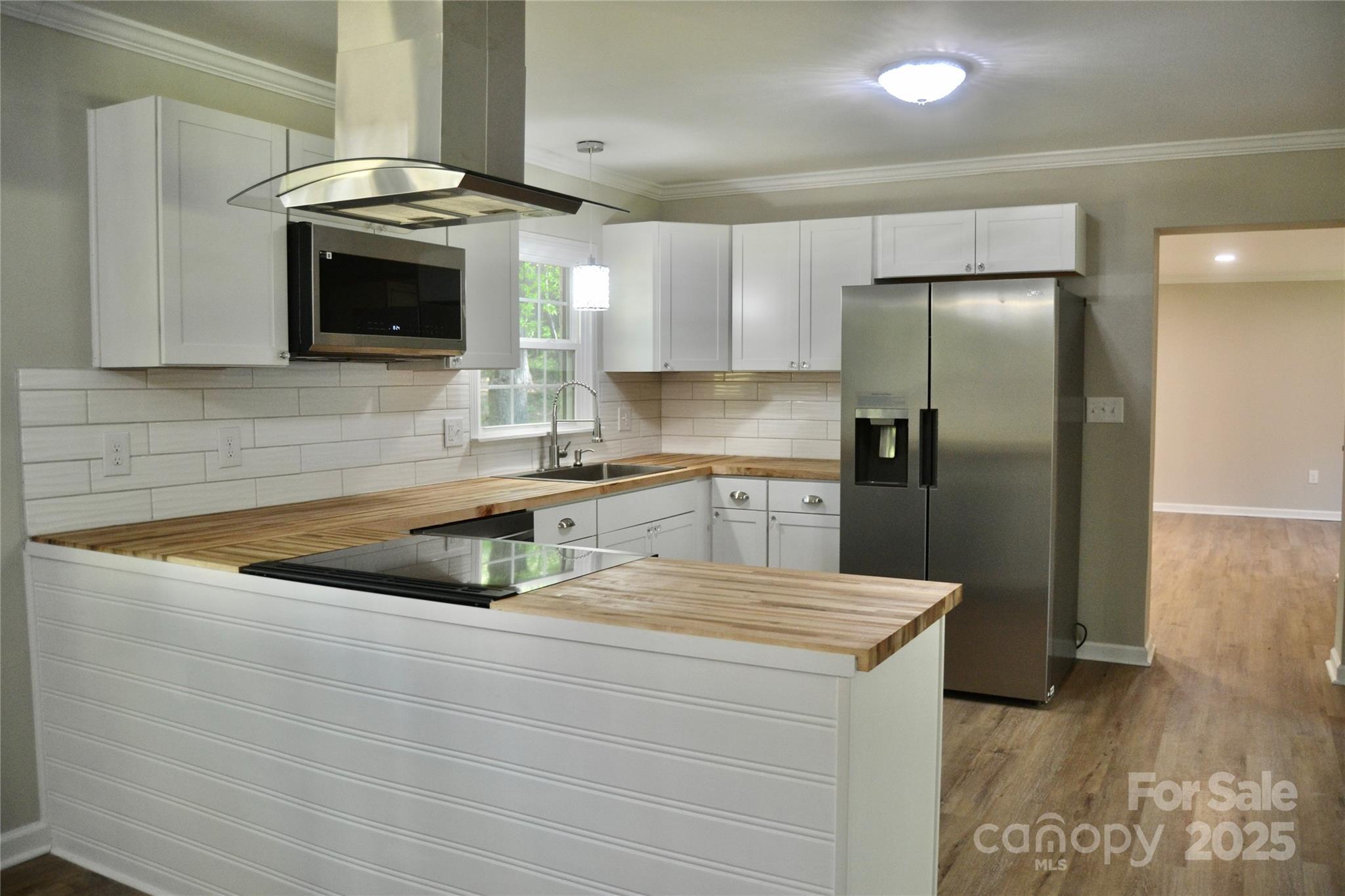 6726 Lockhart Road Sharon, SC 29742 - Photo 9 of 23 a kitchen with stainless steel appliances granite countertop a sink a microwave a refrigerator and a stove