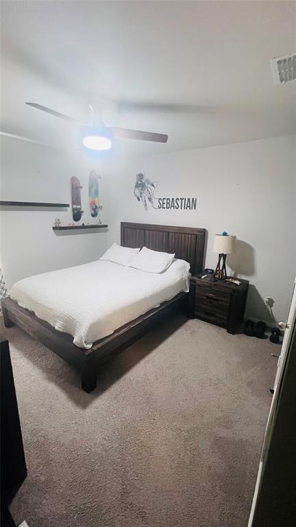 16729 Milwaukee Street Justin, TX 76247 - Photo 14 of 23 a bedroom with a bed and a lamp on table