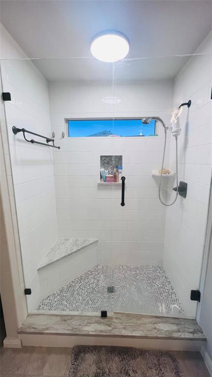 16729 Milwaukee Street Justin, TX 76247 - Photo 19 of 23 a bathroom with a window and a shower