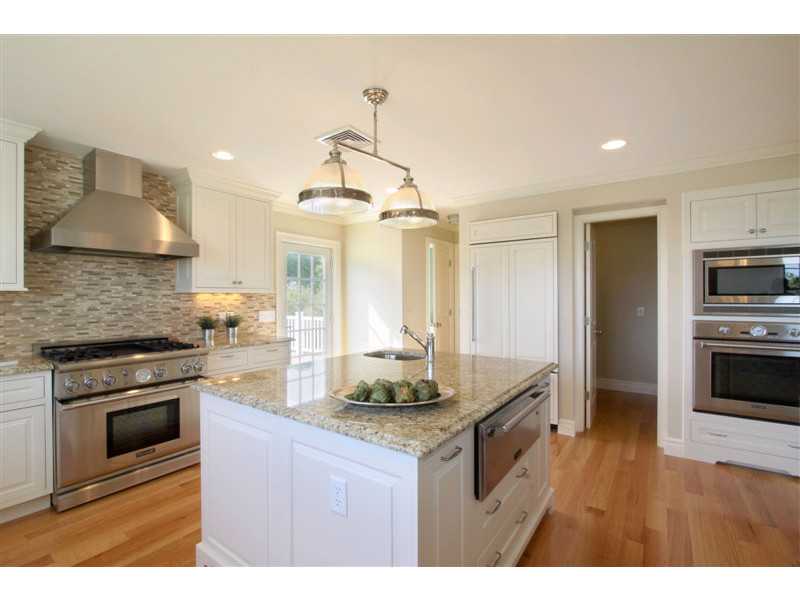 426 Tuckerman Avenue Middletown, RI 02842 - Photo 6 of 32 Looking towards back deck which is ideal for grilling, and half bath down the hallway to the left of the refrigerator. Also pictured is a spacious walk-in pantry.