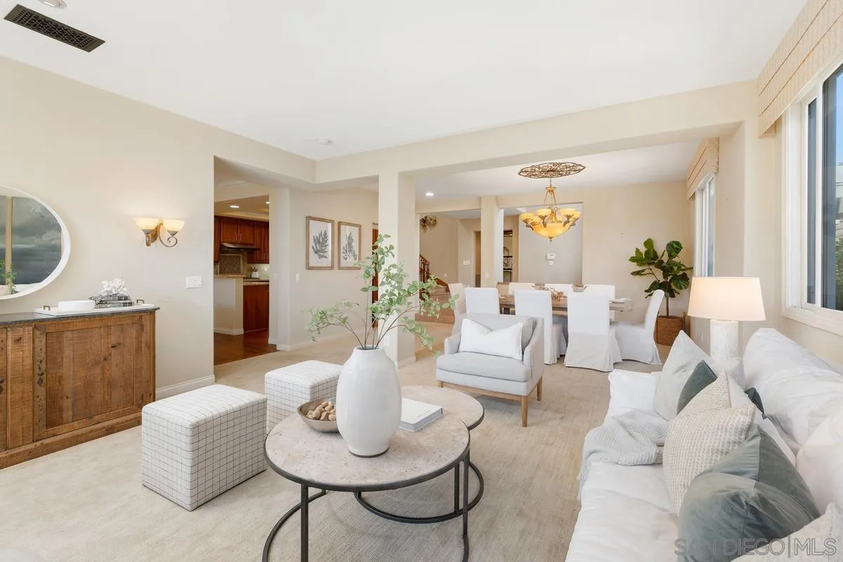 a living room with furniture a rug and a mirror