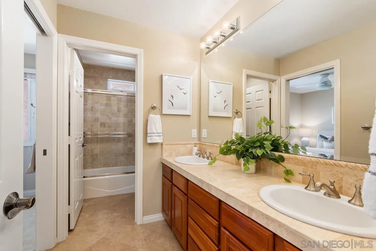 1329 Caminito Balada La Jolla, CA 92037 - Photo 22 of 31 a bathroom with a double vanity sink mirror and shower