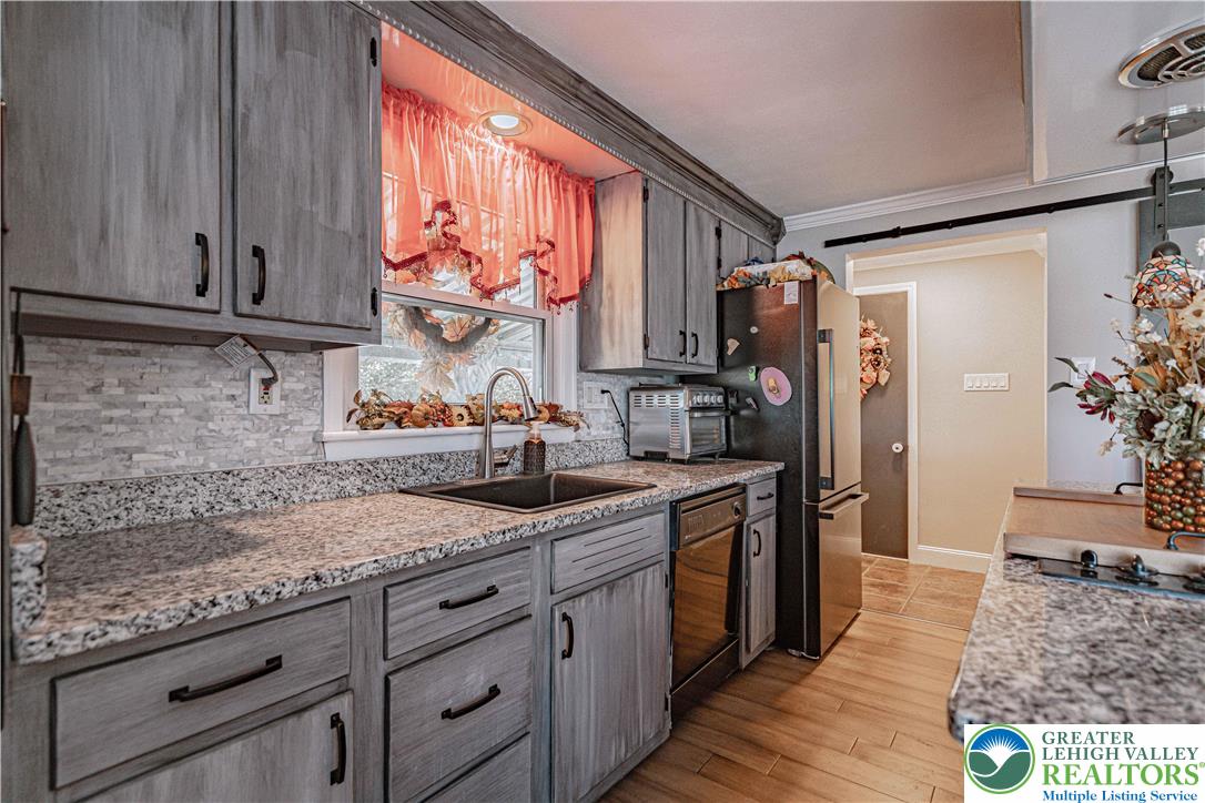 544 School Road Nazareth, PA 18064 - Photo 12 of 35 a kitchen with stainless steel appliances granite countertop a sink stove and refrigerator