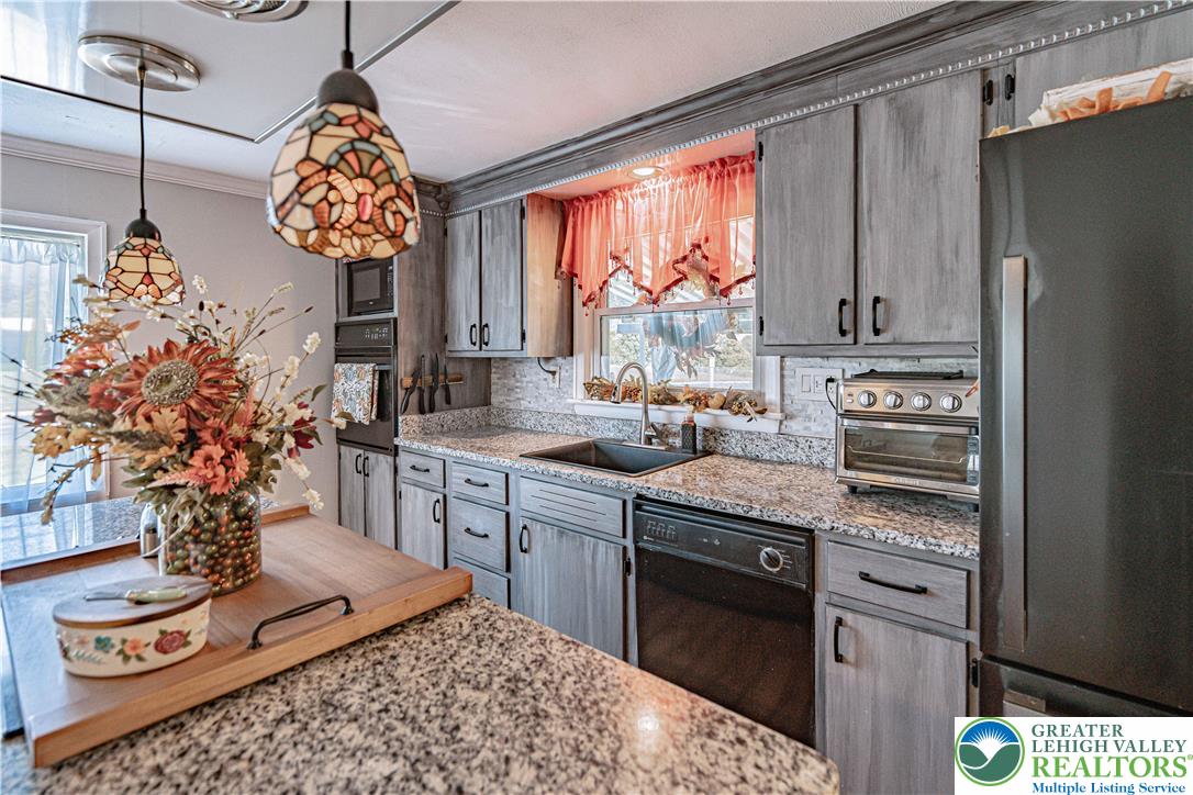 544 School Road Nazareth, PA 18064 - Photo 13 of 35 a kitchen with stainless steel appliances granite countertop a stove a sink and a refrigerator