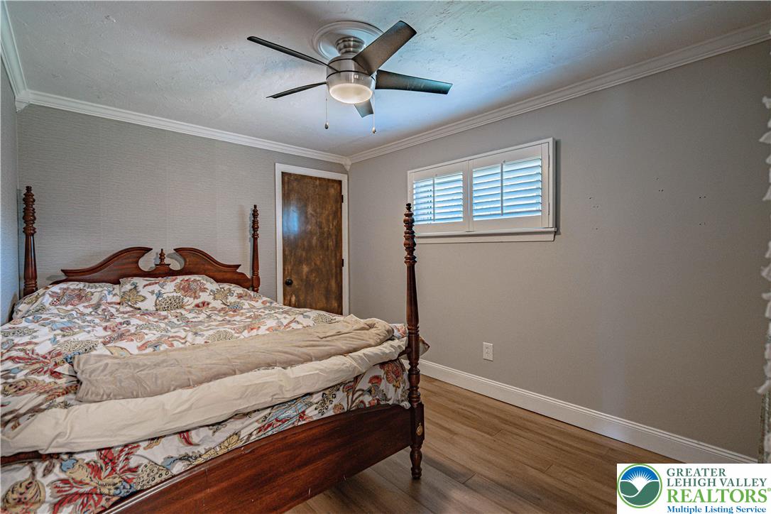 544 School Road Nazareth, PA 18064 - Photo 22 of 35 a bedroom with a bed and a chandelier