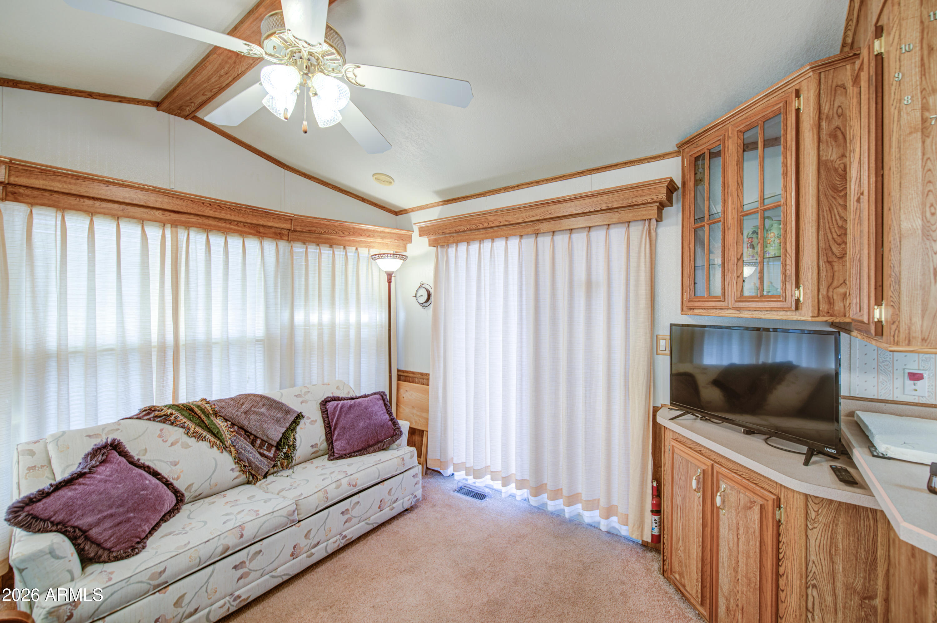 7750 East Broadway Road, Unit 512 Mesa, AZ 85208 - Photo 12 of 32 a living room with furniture and a flat screen tv